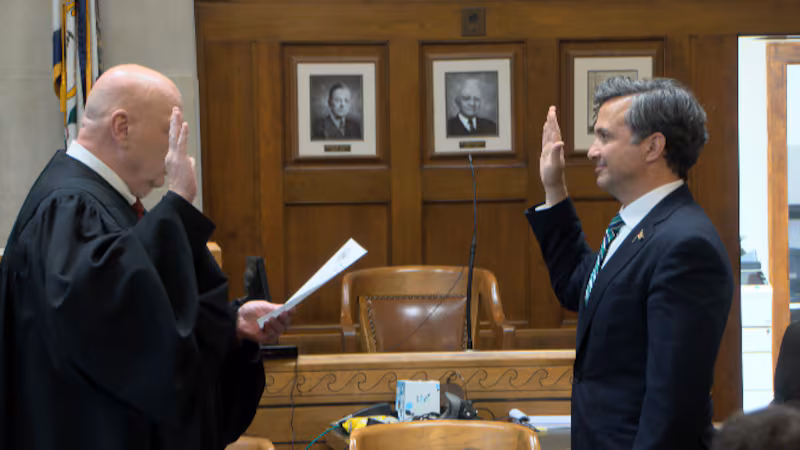 Judge Ryan Flanigan (right) gets sworn in by Judge Mark Wills.